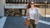 Woman with sunglasses and handbag over her shoulder