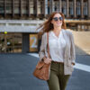 Woman with sunglasses and handbag over her shoulder