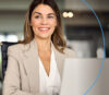 Smiling woman in front of laptop discovers the diverse functions of onOffice enterprise.