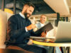 A man and a woman in a meeting with a tablet
